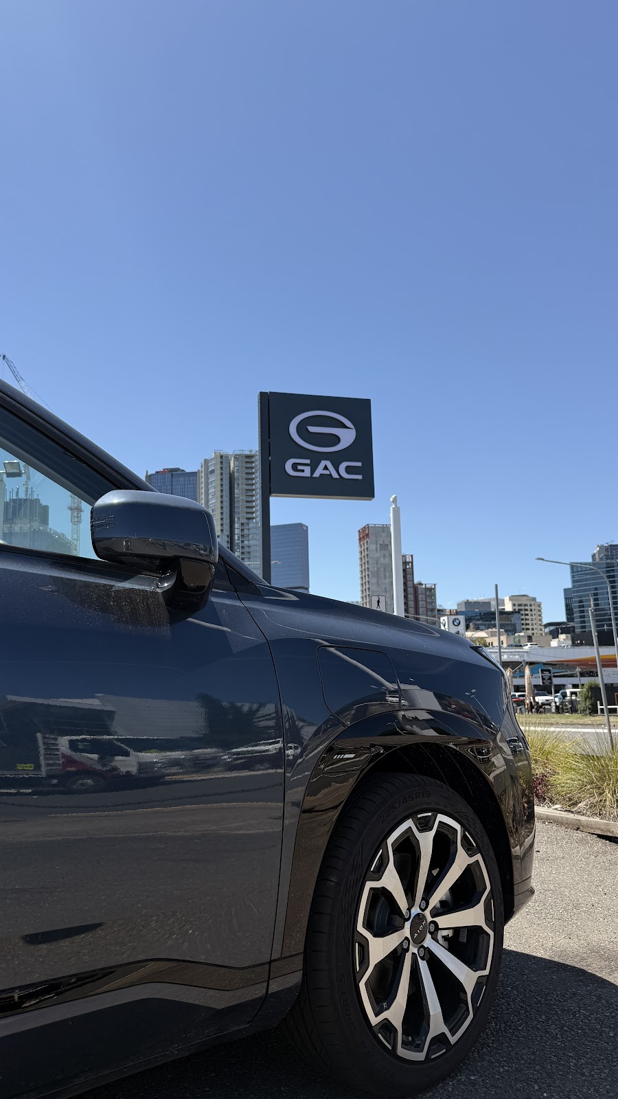 The GAC pylon sign on Church Street, Parramatta, with the Parramatta CBD towers and construction cranes behind it.